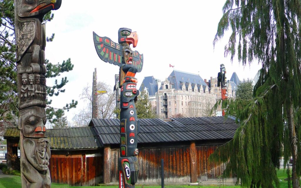 thunderbird park in victoria with the empress hotel in the background