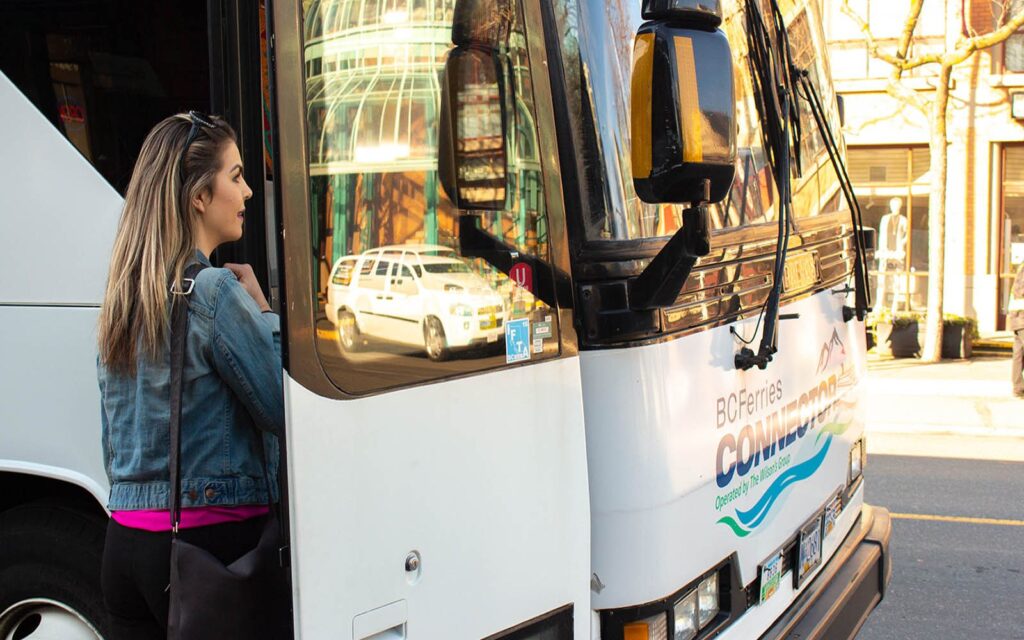 a woman boards the bc ferries connector bus in downtown victoria