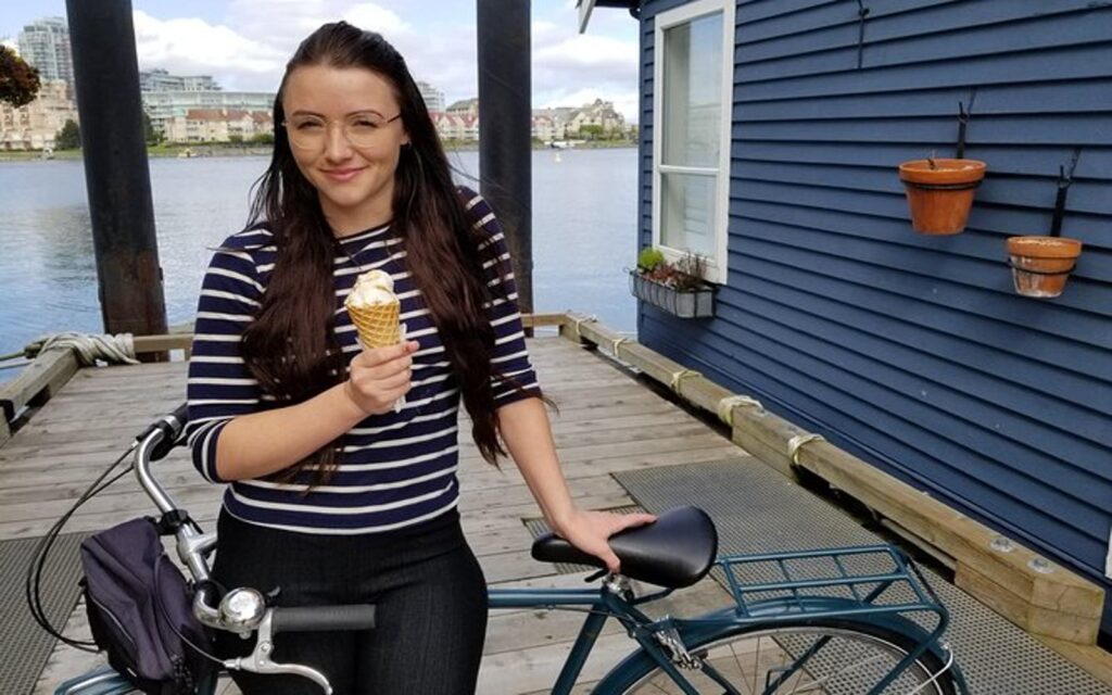 a woman enjoys an ice cream on the eat, drink, pedal bike tour in victoria