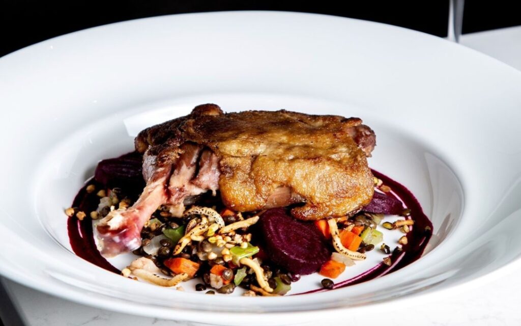 crispy pan roasted quail over seasonal vegetables at the courtney room, victoria, bc