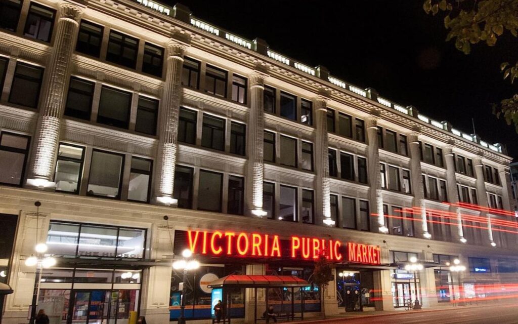 an exterior photo of the victoria public market during the holidays.