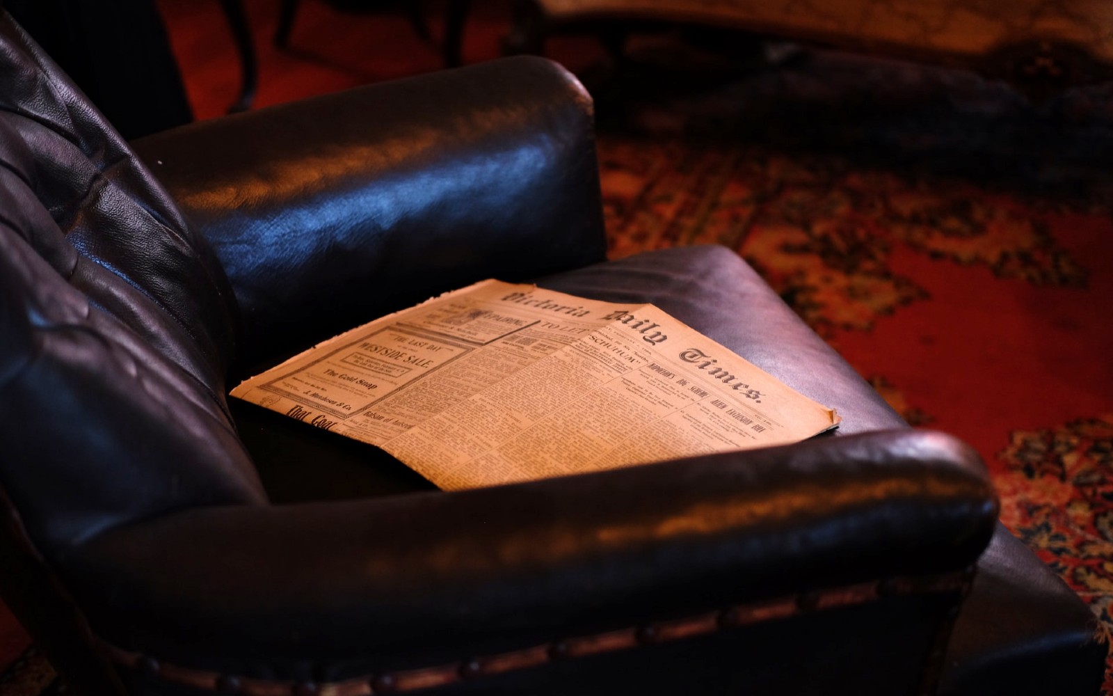 sofa with vintage newspaper at craigdarroch castle in victoria bc
