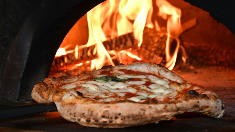 A marghertita pizza comes out of the oven at Pizzeria Prima Strada, our choice for the best pizza in Victoria.
