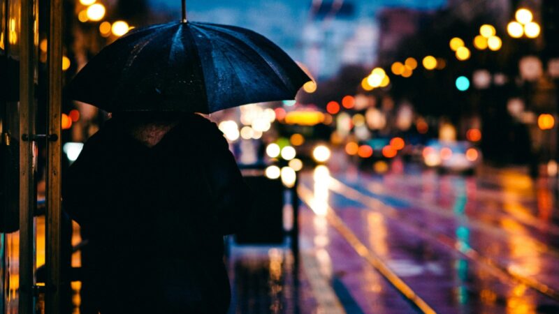 A man wonders what to do in Victoria in the rain.